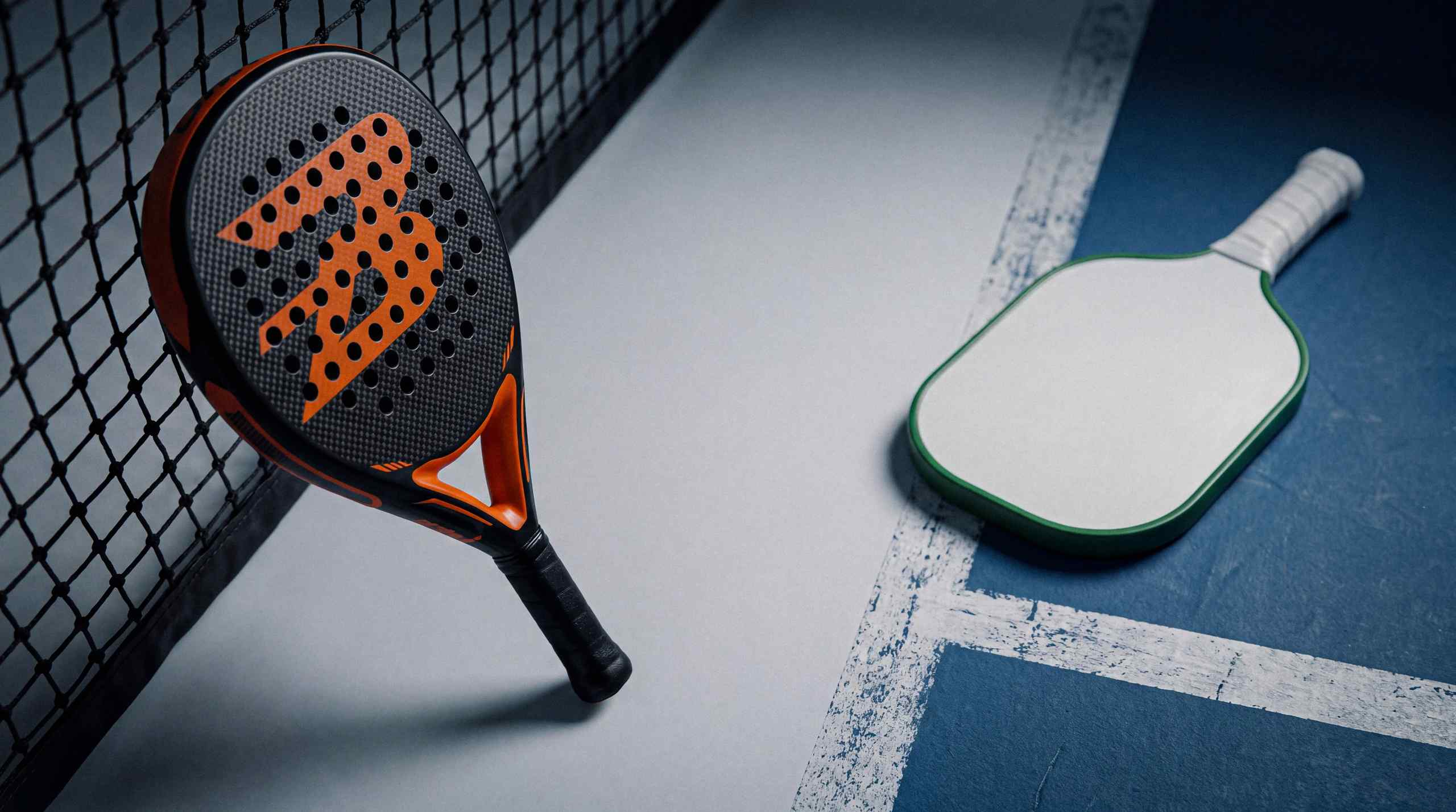 Pickleball paddles set on an empty court.